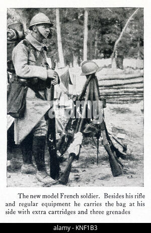 The caption for this photo that dates to between 1914 and 1917 (time of the First World War) reads: The new model French soldier. Besides his rifle and regular equipment he carries the bag at his side with extra cartridges and three grenades. Stock Photo