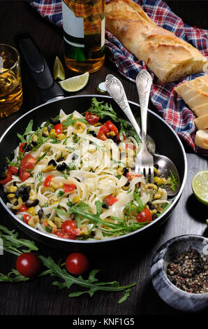 Pasta with crushed olives and cherry tomatoes, arugula. Stock Photo