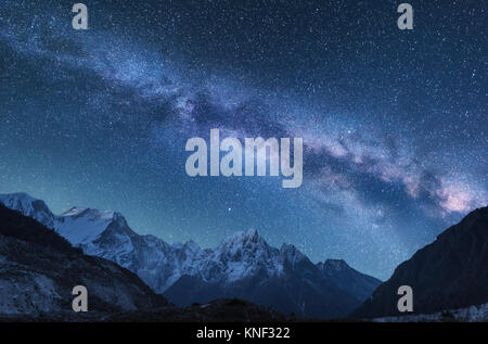 Milky Way and mountains. Amazing scene with himalayan mountains and starry sky at night in Nepal. Rocks with snowy peak and sky with stars. Beautiful  Stock Photo