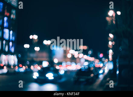 Blurred city at night. Bokeh. Beautiful abstract background with defocused buildings, cars, city lights, people. Colorful bokeh background with urban  Stock Photo