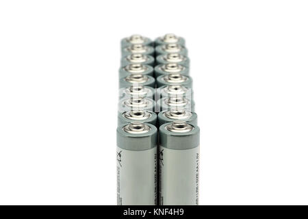 Two series of standing AA batteries, isolated on white background, with blur Stock Photo