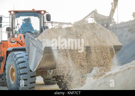 Quarry worker using heavy machinery in quarry Stock Photo