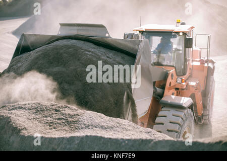 Quarry worker using heavy machinery in quarry Stock Photo