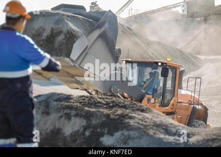 Quarry worker using heavy machinery in quarry Stock Photo