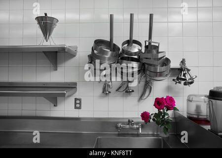 Utensils on metal rack in commercial kitchen Stock Photo - Alamy