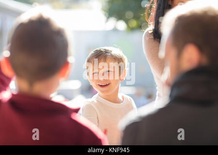 Mid adult man with young boys, playing outdoors Stock Photo