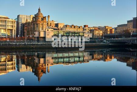 Glasgow, UK, 11th December 2017, Wintery sunrise in Glasgow city centre illuminating the riverside coorporate buildings in a beautiful orange glow. Stock Photo