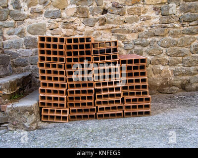Traditional building material. Known as tavelle, forariti ie holed clay bricks. Stock Photo