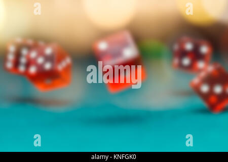 Image of several red dice falling on green table in casino Stock Photo