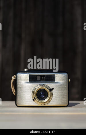 Old vintage golden Penti I camera on wooden background Stock Photo