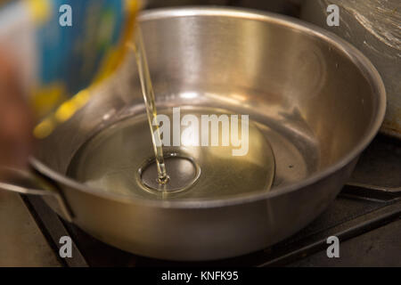 Food Preparation. Oil being poured into a frying pan. Stock Photo