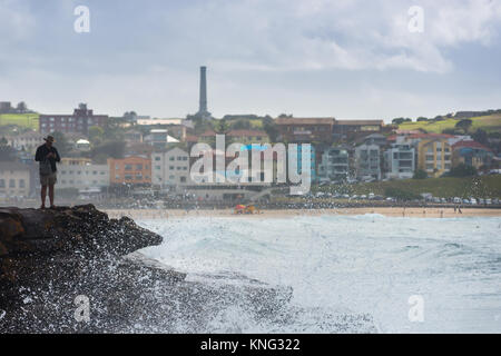 Sea spray from wave hitting rocks off the coastal walk between Bondi and Bronte beaches. Eastern suburbs, Sydney, Australia. Stock Photo