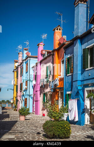 The colorful buildings, canals and boats in the Venetian village of Burano, Venice, Italy, Europe. Stock Photo