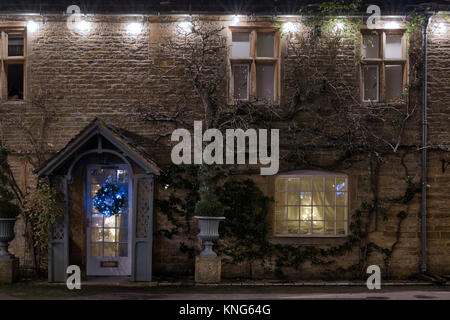 Christmas decorations on the front of a stone town house in the market place of Stow on the Wold, Cotswolds, Gloucestershire, England Stock Photo
