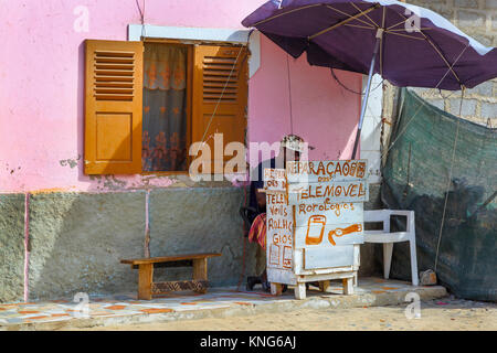 Man repairing watches and mobile phones from a small stall in a back street of Santa Maria, Sal Island, Cape Verde, Africa Stock Photo