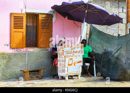 Man repairing watches and mobile phones from a small stall in a back street of Santa Maria, Sal Island, Cape Verde, Africa Stock Photo