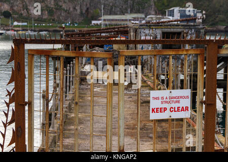 The closed off entrance to the derelict fishing quay at breakwater, Brixham, Torbay, Devon, UK Stock Photo