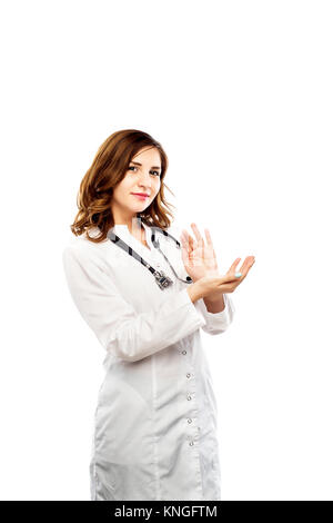 A female doctor in a gown and with stethoscope hanging on her neck is preparing for an injection Stock Photo