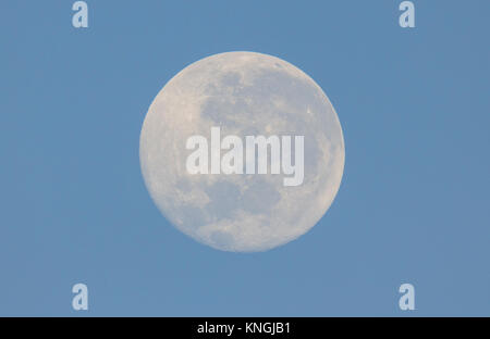 Full moon viewed from Australia Southern Hemisphere during the day with blue sky Stock Photo