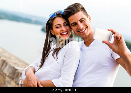 Young beautiful couple taking a selfie of themselves Stock Photo