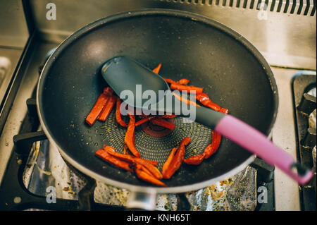 Preparing food in the frying pan. Kitchen in the fast food restaurant Stock Photo