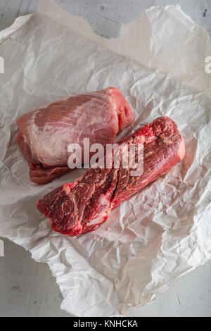 Beef and pork meat on white concrete background. Stock Photo