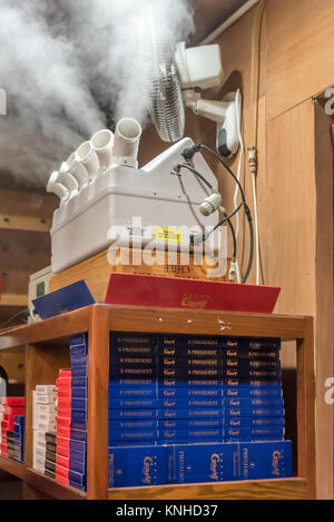 A humidor at work in a storage room of cigar boxes at Graycliff Cigar Company in Nassau, Bahamas. Stock Photo