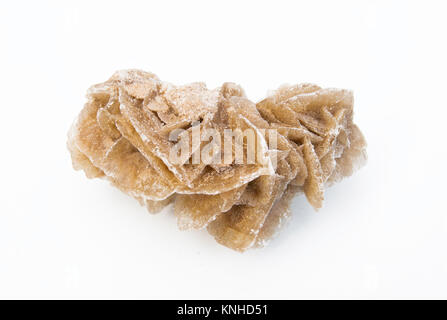 extreme close up of Desert rose gypsum mineral isolated over white background with sand grains Stock Photo