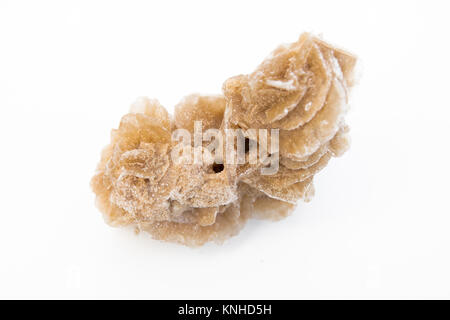 extreme close up of Desert rose gypsum mineral isolated over white background with sand grains Stock Photo