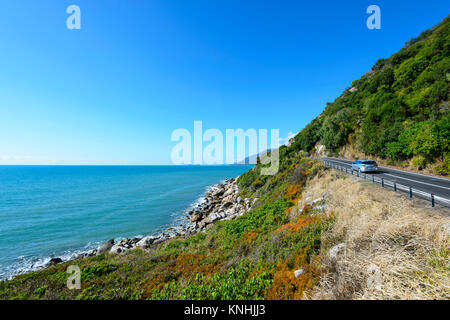 Car driving on the Captain Cook Highway along the scenic coastline, between Cairns and Port Douglas, Far North Queensland, FNQ, QLD, Australia Stock Photo