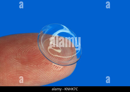 Contact lens on the tip of finger Stock Photo