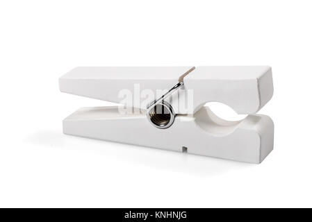 Single isolated white wooden clothes peg with metal hinge over a matching white background Stock Photo