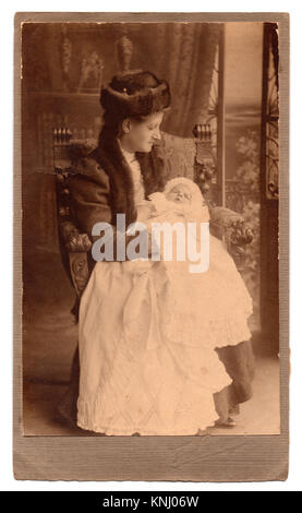 Edith Johnson and baby Beryl, 1910: studio portrait. Stamped below the photograph is the studio photographer's name and address: 'Fred Parsons, 128 The Broadway, Southend-on-Sea'