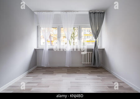 Empty room with floor panels and window curtains Stock Photo
