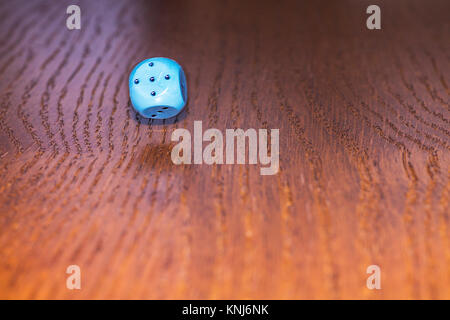 The dice roll on the wooden table. Role-playing game Dungeons and Dragons. Gambling in the casino. Stock Photo