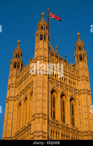 London, UK. 8th December, 2017. Late afternoon sunlight on a Union flag flying above the Palace of Westminster. Stock Photo