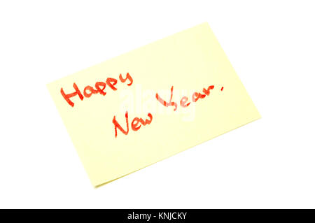 Happy new year writen on yellow sheet, white background Stock Photo