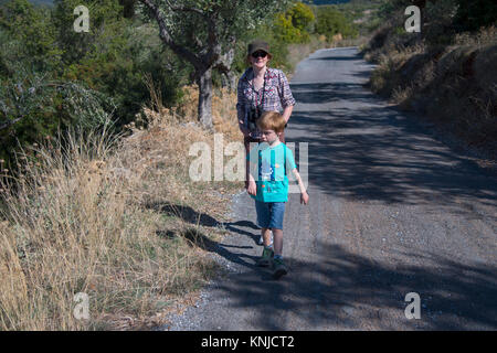 Young boy (5 years old) walking with his mother on holiday in the countryside near  Kardamyli, Greece Stock Photo