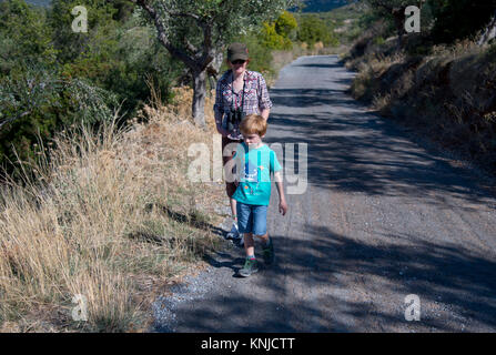 Young boy (5 years old) walking with his mother on holiday in the countryside near  Kardamyli, Greece Stock Photo