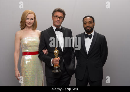 HOLLYWOOD, CA - FEBRUARY 22: Presenters actress Nicole Kidman and actor Chiwetel Ejiofor pose backstage with Pawel Pawlikowski (center) and his Oscar® for Best foreign language film of the year, for work on “Ida” from Poland during the live ABC Telecast of The 87th Oscars® at the Dolby® Theatre in Hollywood, CA on Sunday, February 22, 2015. Stock Photo