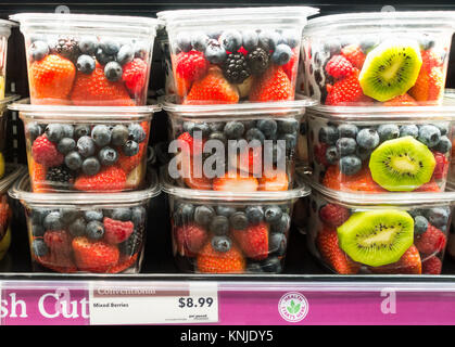 Mixed cut berries in plastic containers on a supermarket shelf in New York City Stock Photo