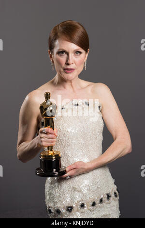 HOLLYWOOD, CA - FEBRUARY 22: Julianne Moore poses backstage with the Oscar® for Performance by an actress in a leading role, for work on “Still Alice” during the live ABC Telecast of The 87th Oscars® at the Dolby® Theatre in Hollywood, CA on Sunday, February 22, 2015. Stock Photo