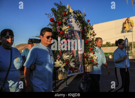 Pilgrimage in honor of the Virgin of Guadalupe or Virgin Mary, also called the Patroness of Mexico. According to popular traditions, on Tuesday December 12, 1531, the Virgin appeared to the indigenous Juan Diego and that is how since then this date has been celebrated with a popular celebration throughout the Mexican territory. Here in Hermosillo believers, faithful and devoted to the mother of Jesus Christ pay tribute and offerings as candles and flowers to the image of the Virgin reflected in a painting on the skirt of Cerro de la Campana located on the outskirts of Hermosillo, Sonora, Mex. Stock Photo