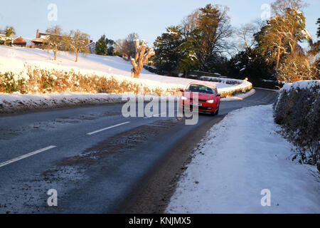 Titley, Herefordshire, UK - December 2017 - Overnight temperatures dropped to minus 9c ( -9c ) in the rural parts of Herefordshire last night - an early morning motorist drives with care on the shade covered road with patches of black ice. Credit: Steven May/Alamy Live News Stock Photo