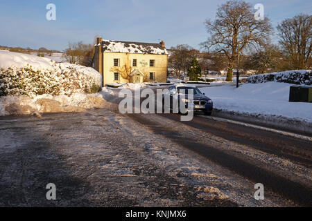 Titley, Herefordshire, UK - December 2017 - Overnight temperatures dropped to minus 9c ( -9c ) in the rural parts of Herefordshire last night - an early morning motorist drives with care on the ice covered road through the village. Credit: Steven May/Alamy Live News Stock Photo