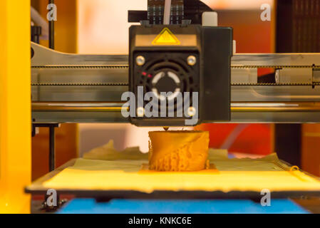 Close up of 3d printing machine printing a piece of plastic Stock Photo