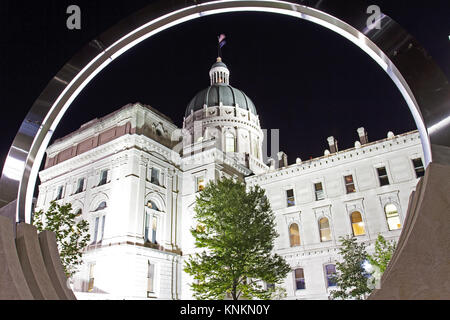 Creative view of the Indiana state house capitol building through a circular sculpture at night Stock Photo