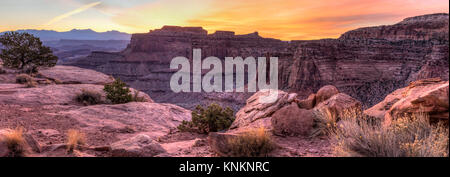 Colorful sunrise over Shafer Canyon, off the Shaefer Trail in Canyonlands National Park, Utah. (Panorama) Stock Photo