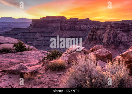 Colorful sunrise over Shafer Canyon, off the Shaefer Trail in Canyonlands National Park, Utah. Stock Photo