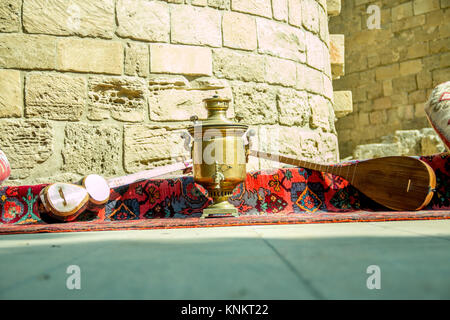 Ancient azerbaijani musical instruments tar and saz with old vintage azeri tea pot for boiling water Stock Photo